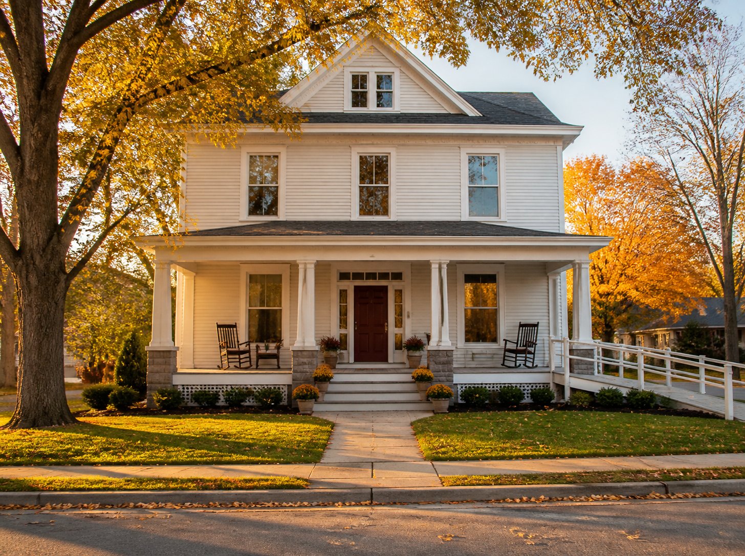 Illustration of a renovated two-story home with a wide front porch and accessible ramp